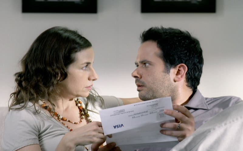 A man and woman holding papers in front of each other.